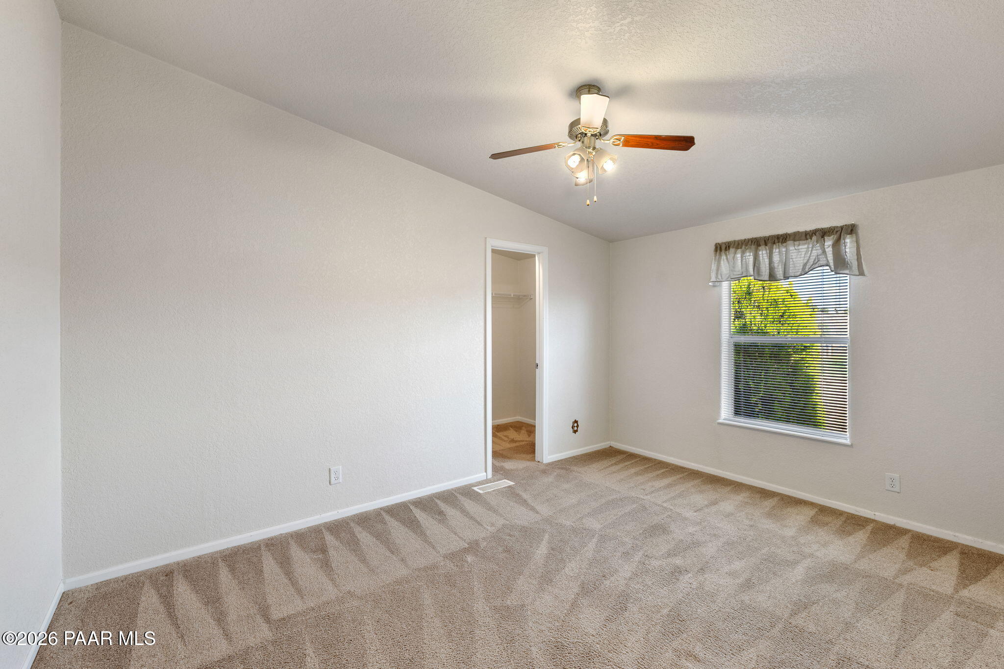 24680 North St Louis Street Paulden, AZ 86334 - Photo 17 of 33 an empty room with windows and fan