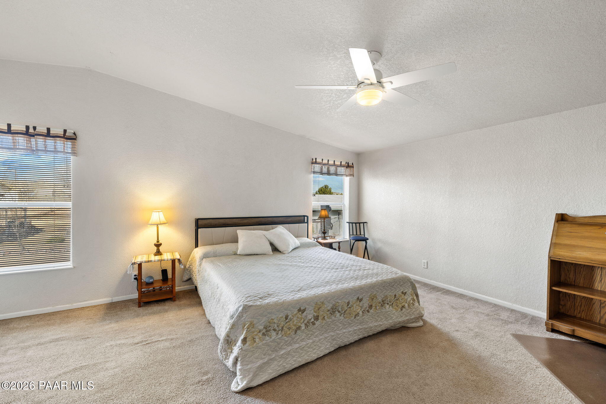 24680 North St Louis Street Paulden, AZ 86334 - Photo 19 of 33 a bedroom with a bed and a chandelier