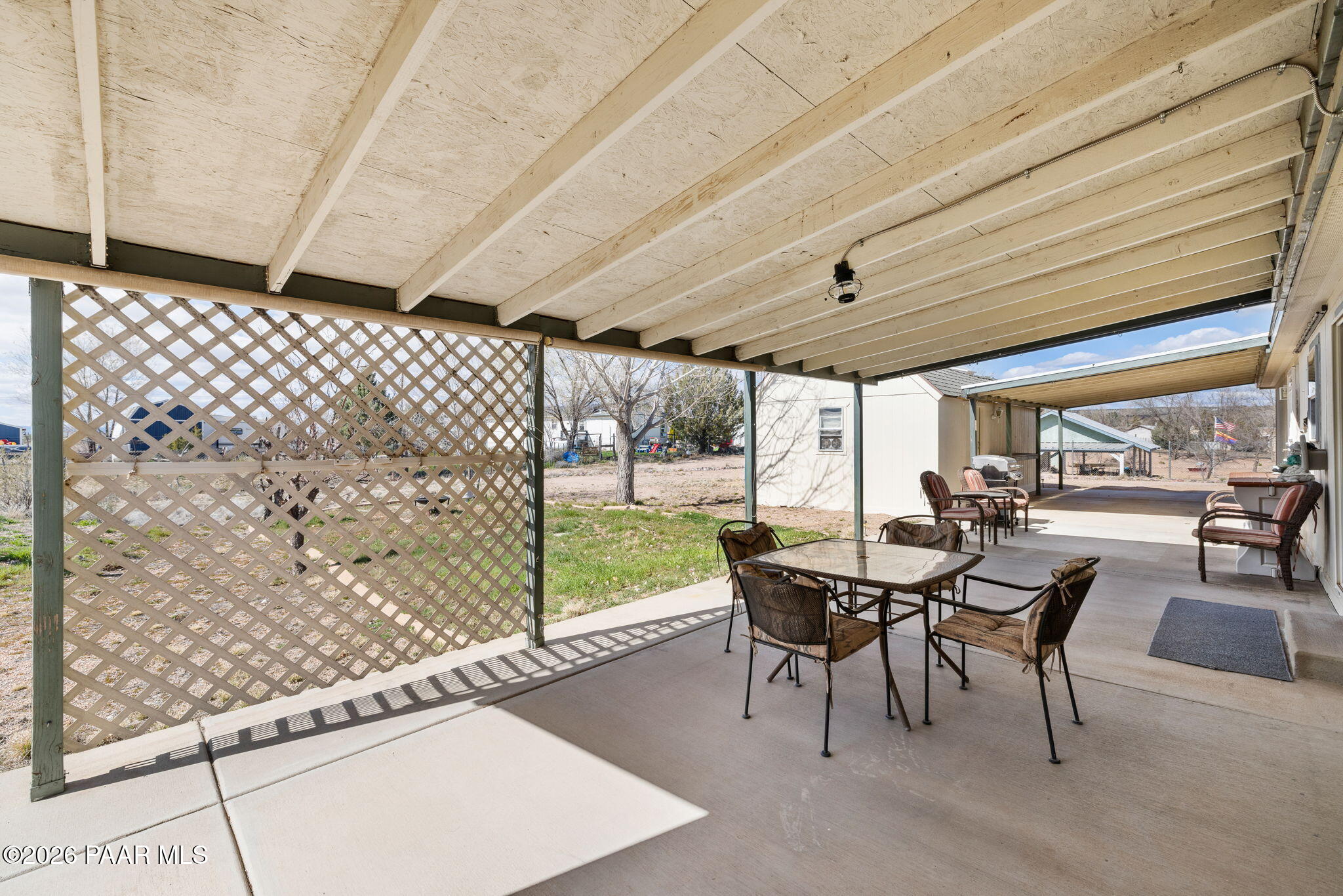 24680 North St Louis Street Paulden, AZ 86334 - Photo 25 of 33 a view of a patio with table and chairs and floor to ceiling window