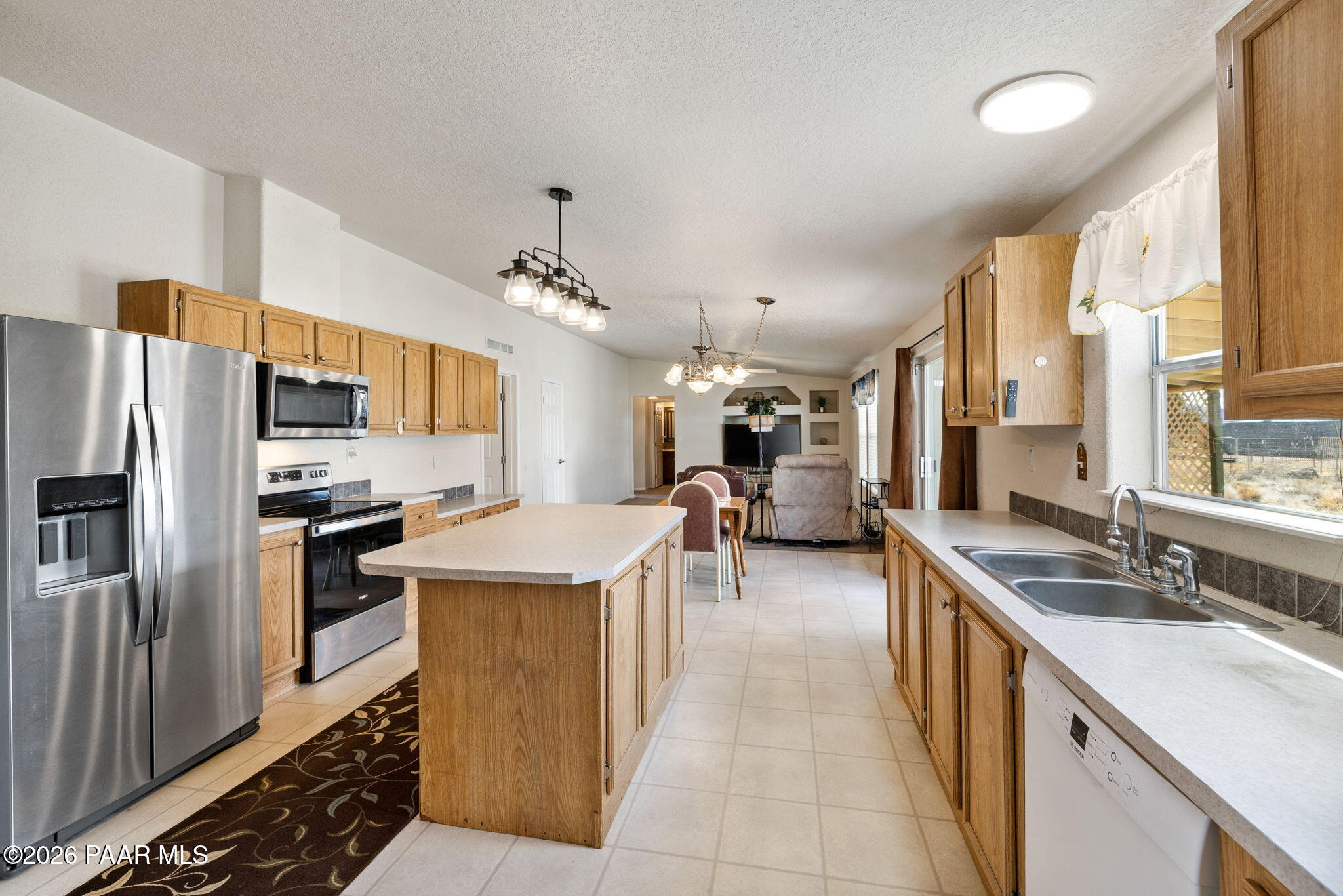 24680 North St Louis Street Paulden, AZ 86334 - Photo 6 of 33 a kitchen with stainless steel appliances granite countertop a sink a stove and a refrigerator