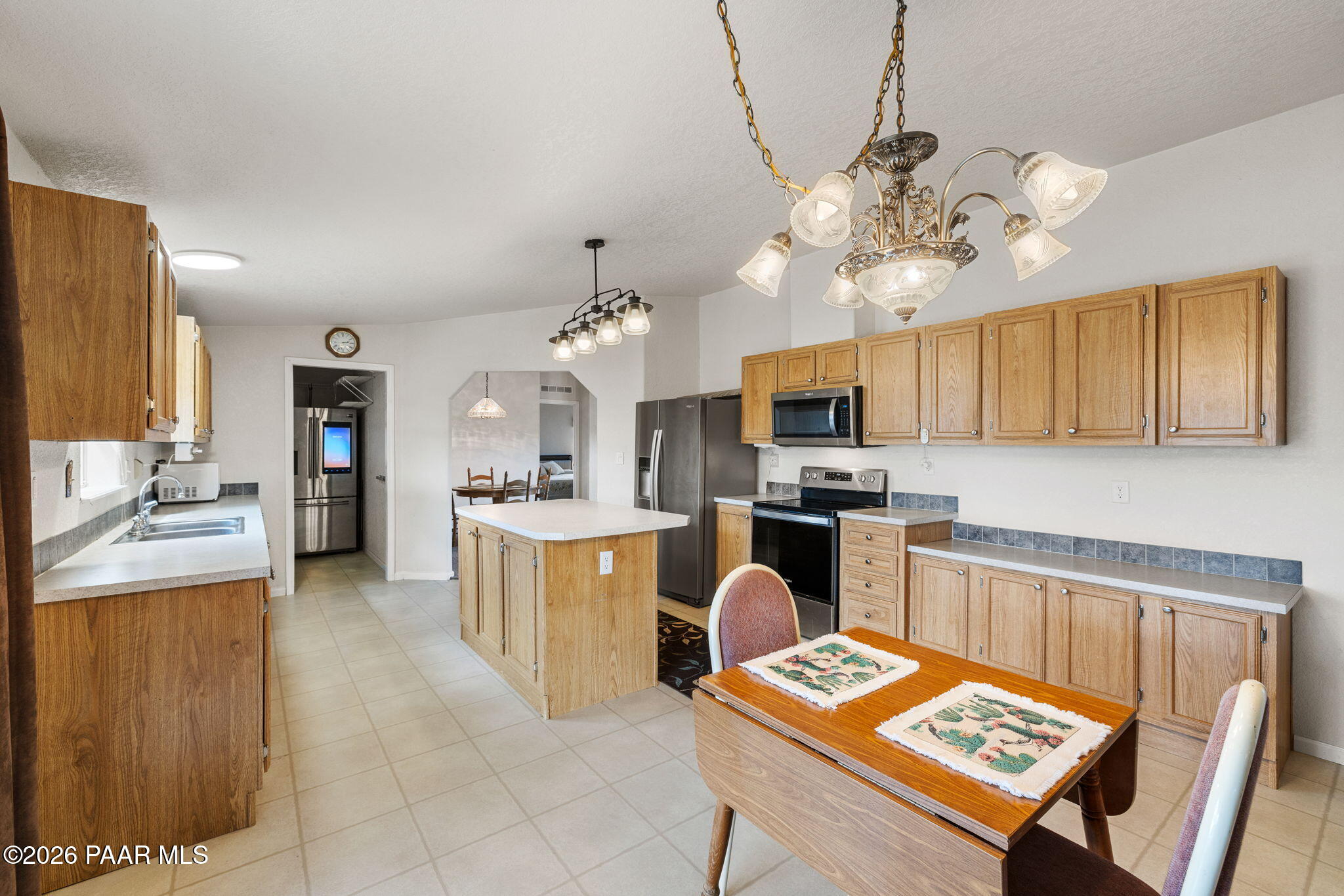 24680 North St Louis Street Paulden, AZ 86334 - Photo 7 of 33 a kitchen with cabinets a counter space stainless steel appliances and a chandelier