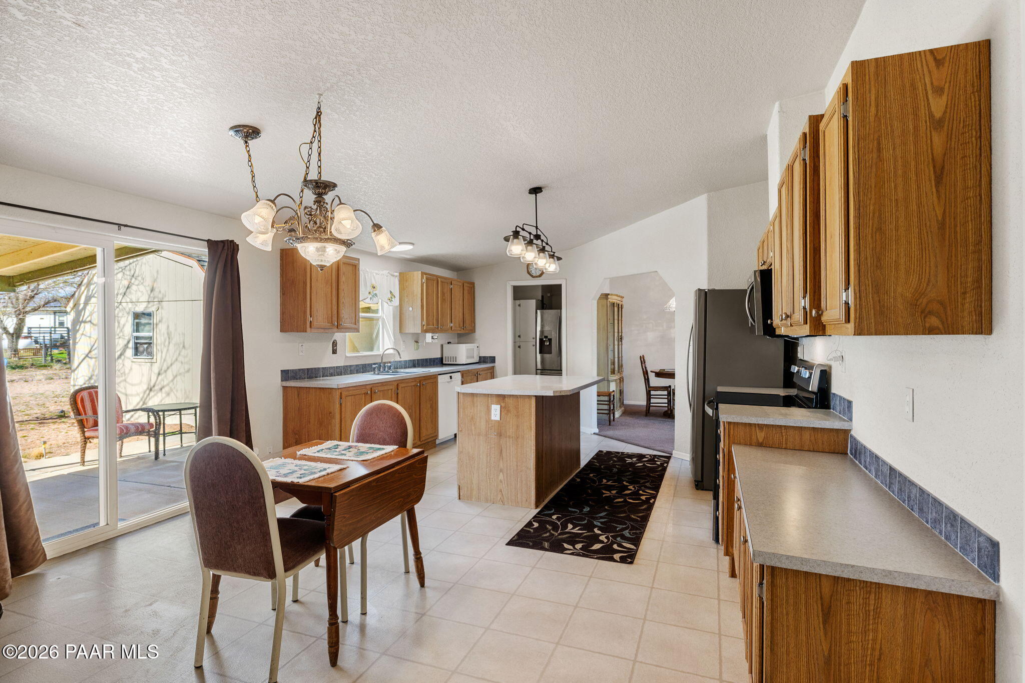 24680 North St Louis Street Paulden, AZ 86334 - Photo 8 of 33 a kitchen with stainless steel appliances a stove a sink dishwasher and cabinets with wooden floor