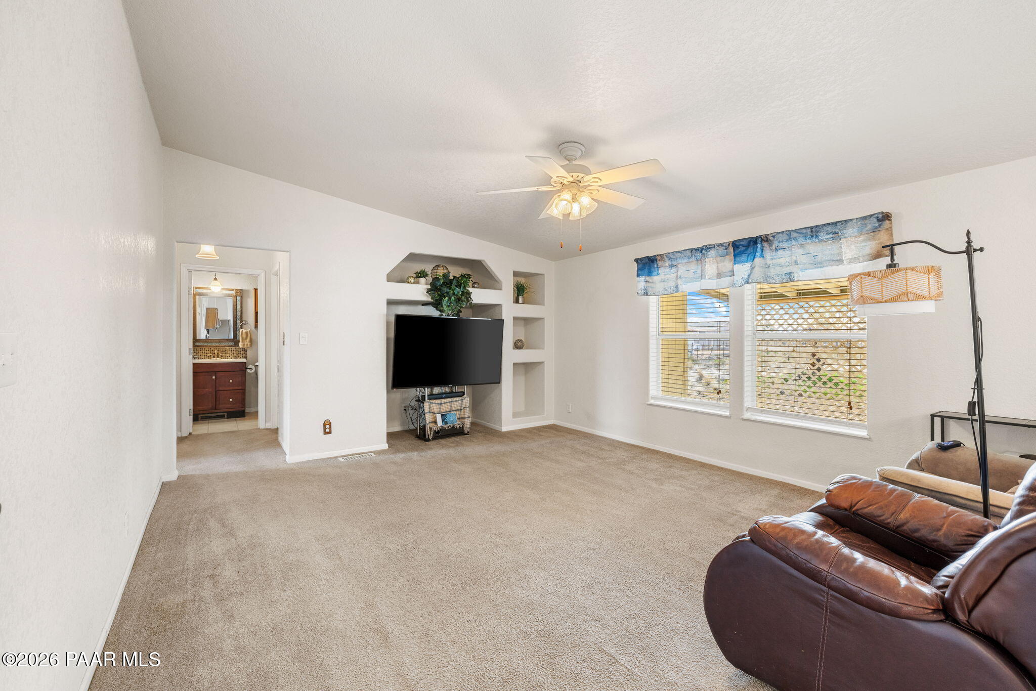 24680 North St Louis Street Paulden, AZ 86334 - Photo 10 of 33 a living room with furniture a ceiling fan and a flat screen tv