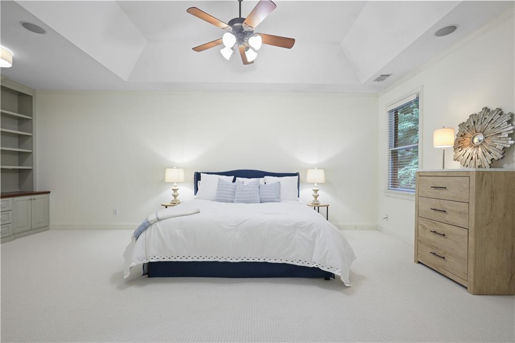 4428 Wilkerson Manor Drive, Unit 6 Smyrna, GA 30080 - Photo 17 of 27 a bedroom with a bed and a chandelier