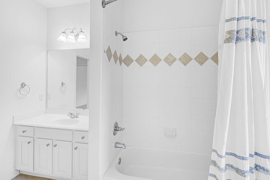 4428 Wilkerson Manor Drive, Unit 6 Smyrna, GA 30080 - Photo 26 of 27 a bathroom with a sink a mirror and a shower