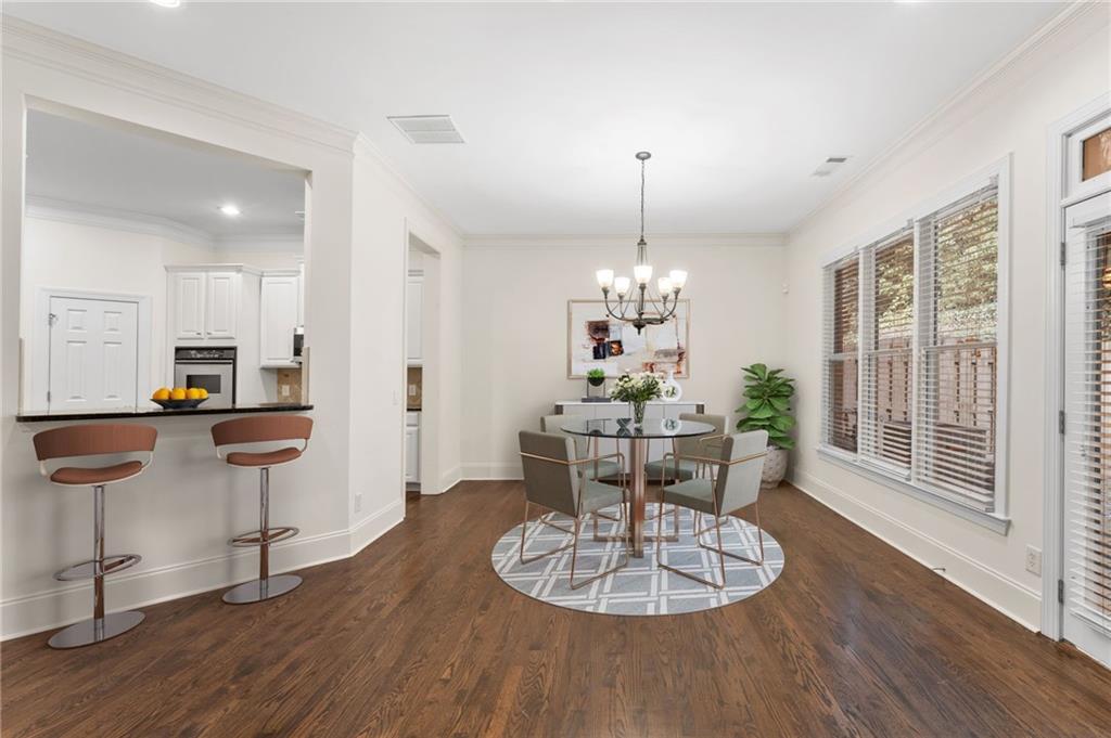 4428 Wilkerson Manor Drive, Unit 6 Smyrna, GA 30080 - Photo 10 of 27 a view of a dining room with furniture a chandelier and wooden floor