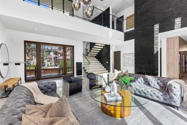 a living room with furniture and a floor to ceiling window