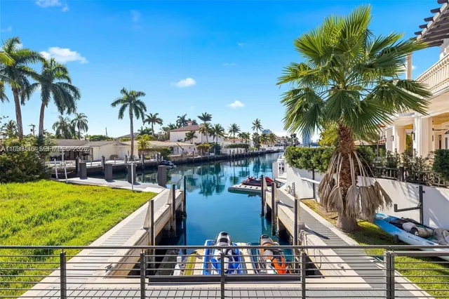 a view of a swimming pool with a chair and palm trees