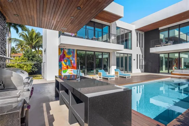 a view of a house with a swimming pool and furniture