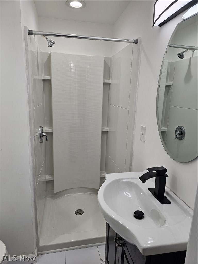 1147 Mayfield Ridge Road Cleveland, OH 44124 - Photo 9 of 23 Bathroom featuring a shower, vanity, tile patterned flooring, and toilet