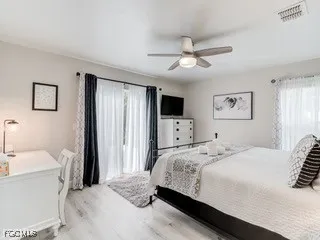 a bedroom with a bed and a large mirror