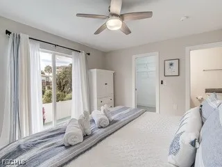 a bedroom with a large bed and a window