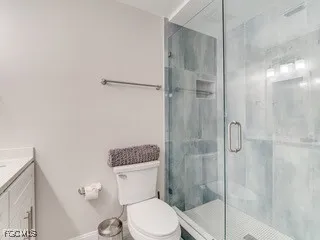 a white toilet sitting next to a bathroom