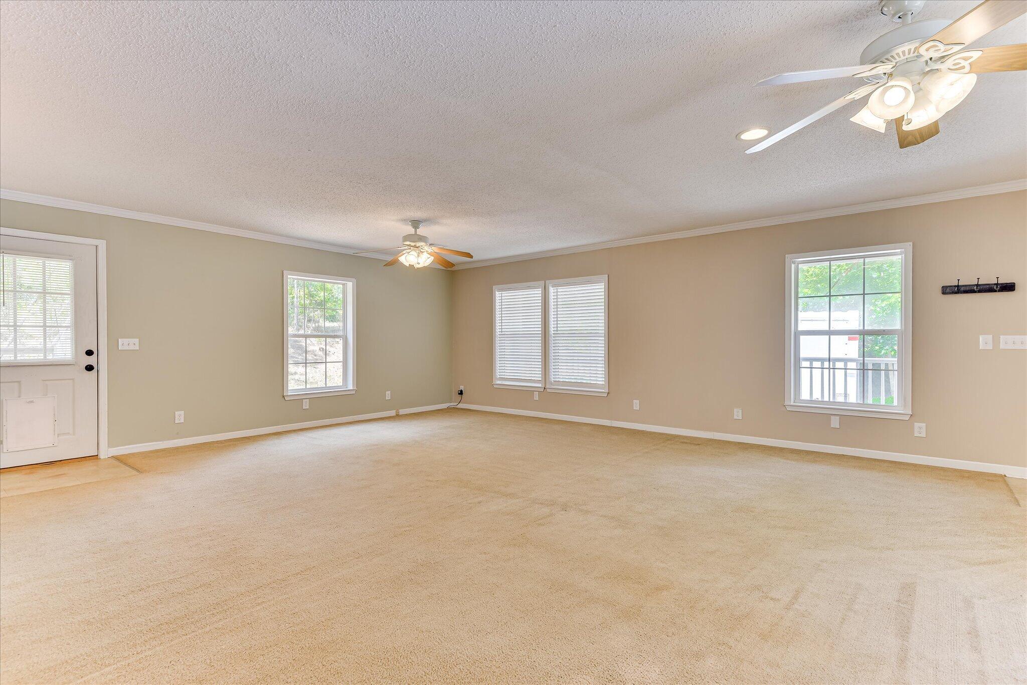 1405 Garrett Road Clarks Hill, SC 29821 - Photo 11 of 51 an empty room with windows and chandelier fan