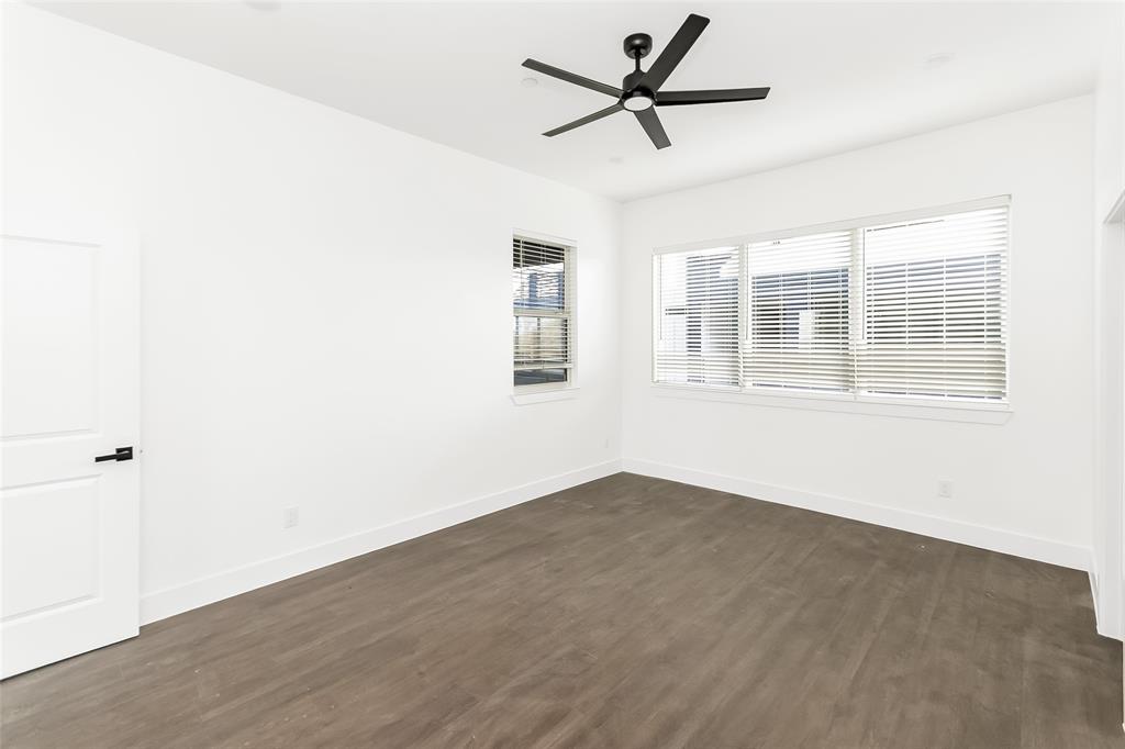 1101 Poindexter Street, Unit A2 Fort Worth, TX 76102 - Photo 12 of 40 an empty room with wooden floor and windows