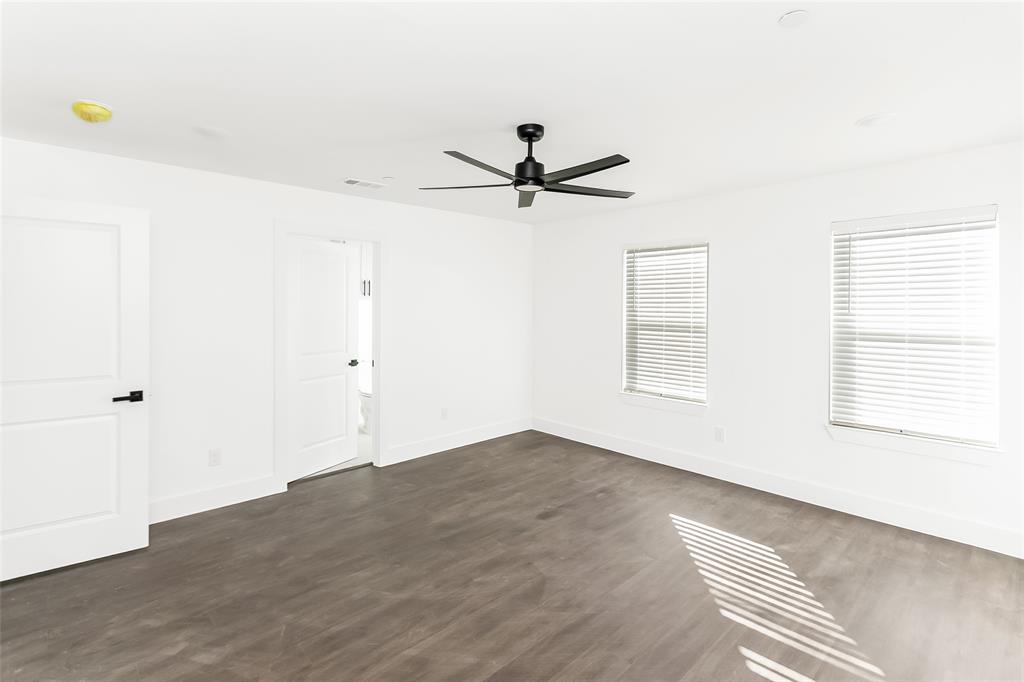 1101 Poindexter Street, Unit A2 Fort Worth, TX 76102 - Photo 19 of 40 a view of a room with a window and a ceiling fan