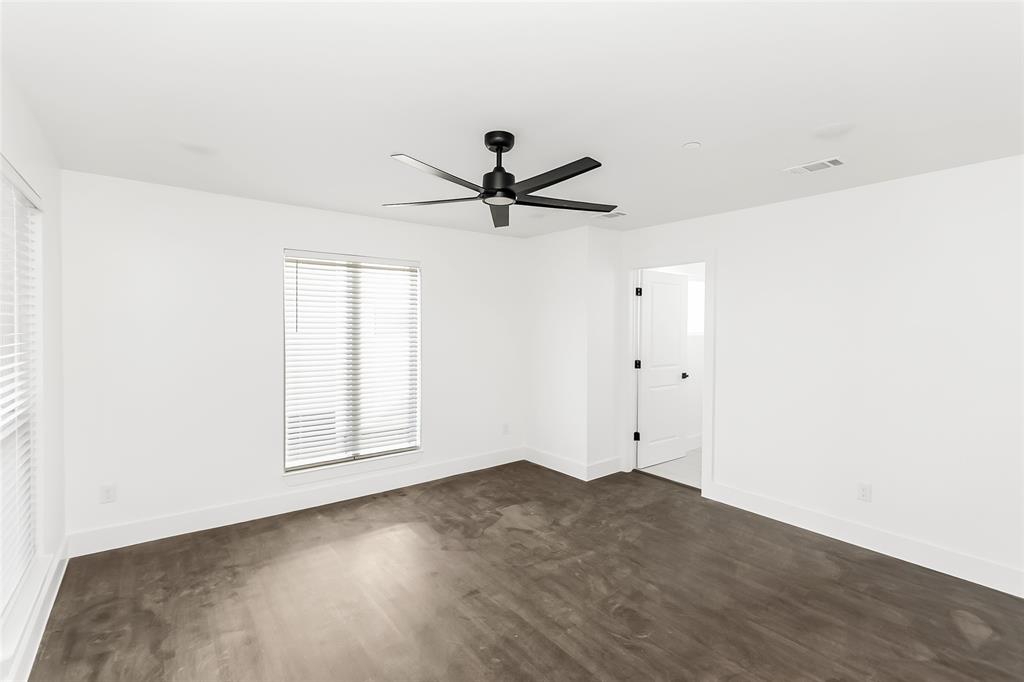 1101 Poindexter Street, Unit A2 Fort Worth, TX 76102 - Photo 24 of 40 an empty room with chandelier fan and windows
