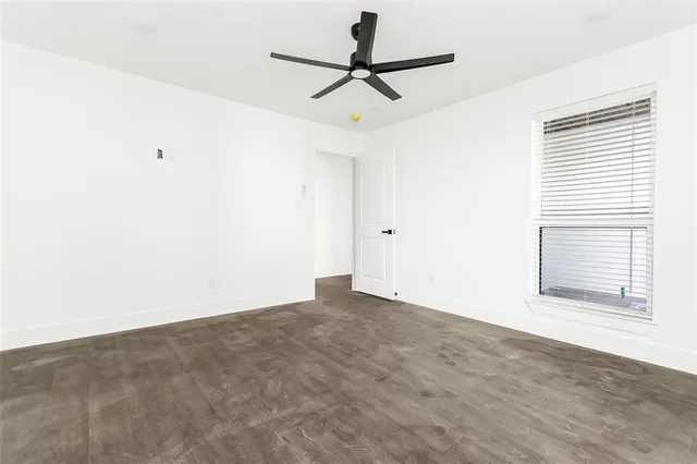 a view of a livingroom with a ceiling fan and window