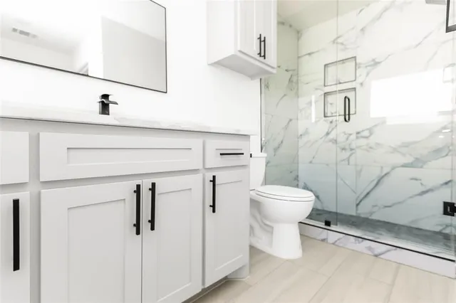 a bathroom with a toilet sink and a shower