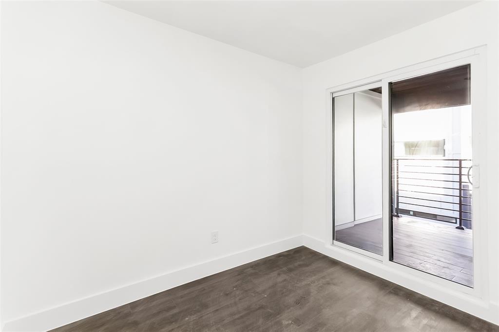 1101 Poindexter Street, Unit A2 Fort Worth, TX 76102 - Photo 30 of 40 a view of an empty room with wooden floor and a window