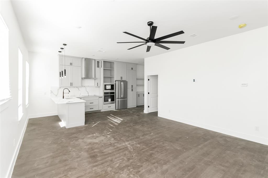1101 Poindexter Street, Unit A2 Fort Worth, TX 76102 - Photo 6 of 40 a view of a kitchen with a sink and a refrigerator