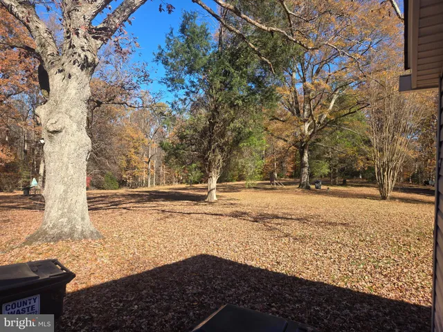 a view of yard covered with snow in front of house