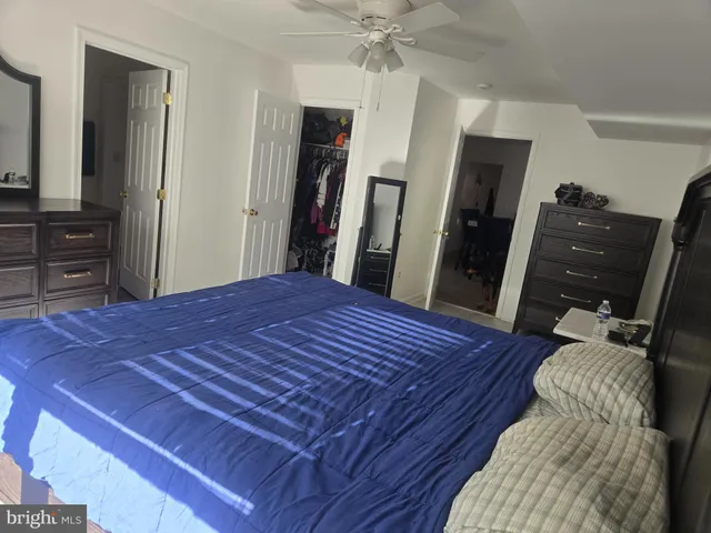 a bed sitting in a bedroom and a flat tv screen