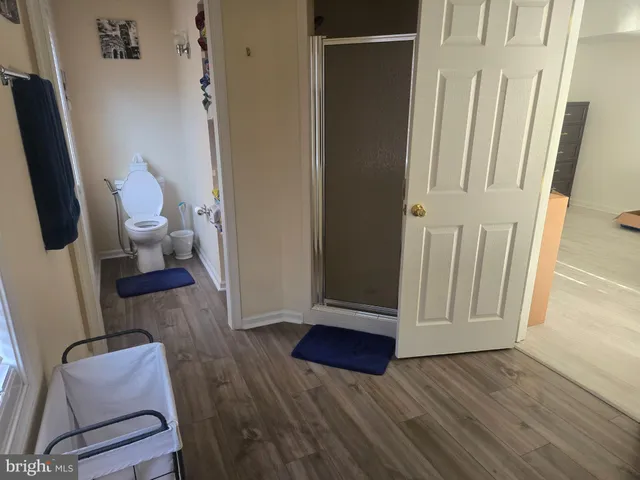 a view of room with wooden floor