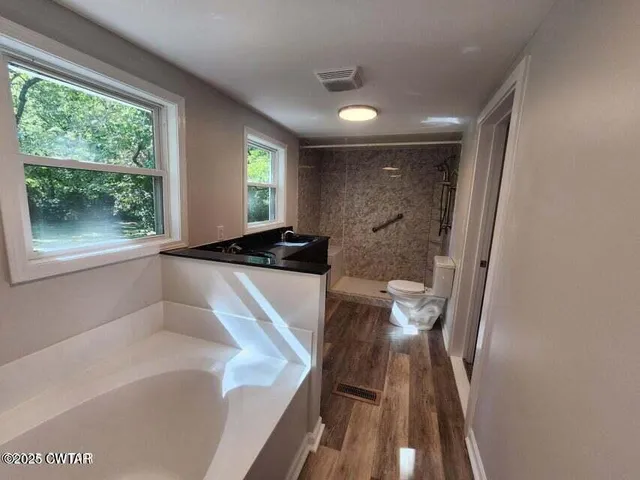 a view of a bathroom with a sink and a large window