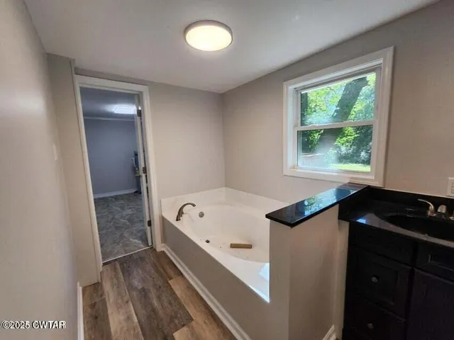 a bathroom with a bathtub and a sink
