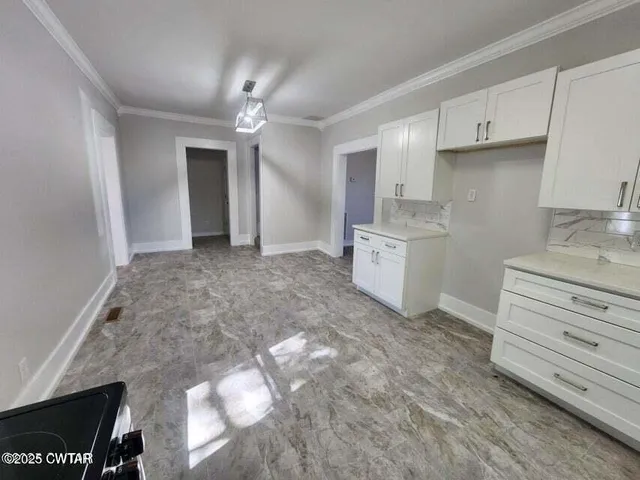 a view of a kitchen with electric appliances