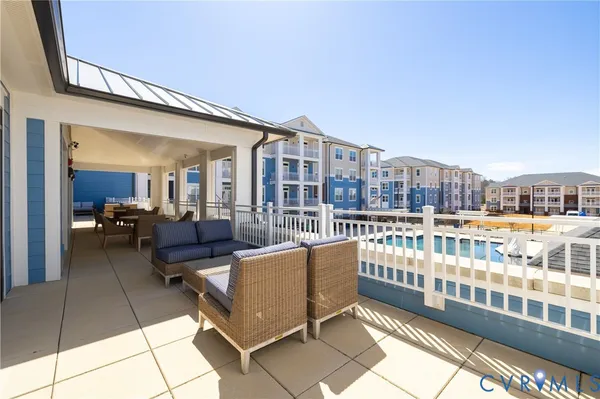 a view of a swimming pool with outdoor seating