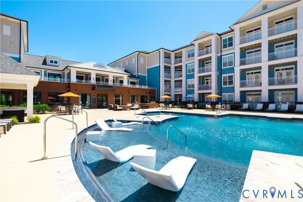a swimming pool with outdoor seating and yard