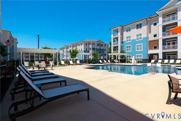 a front view of a building with swimming pool and porch