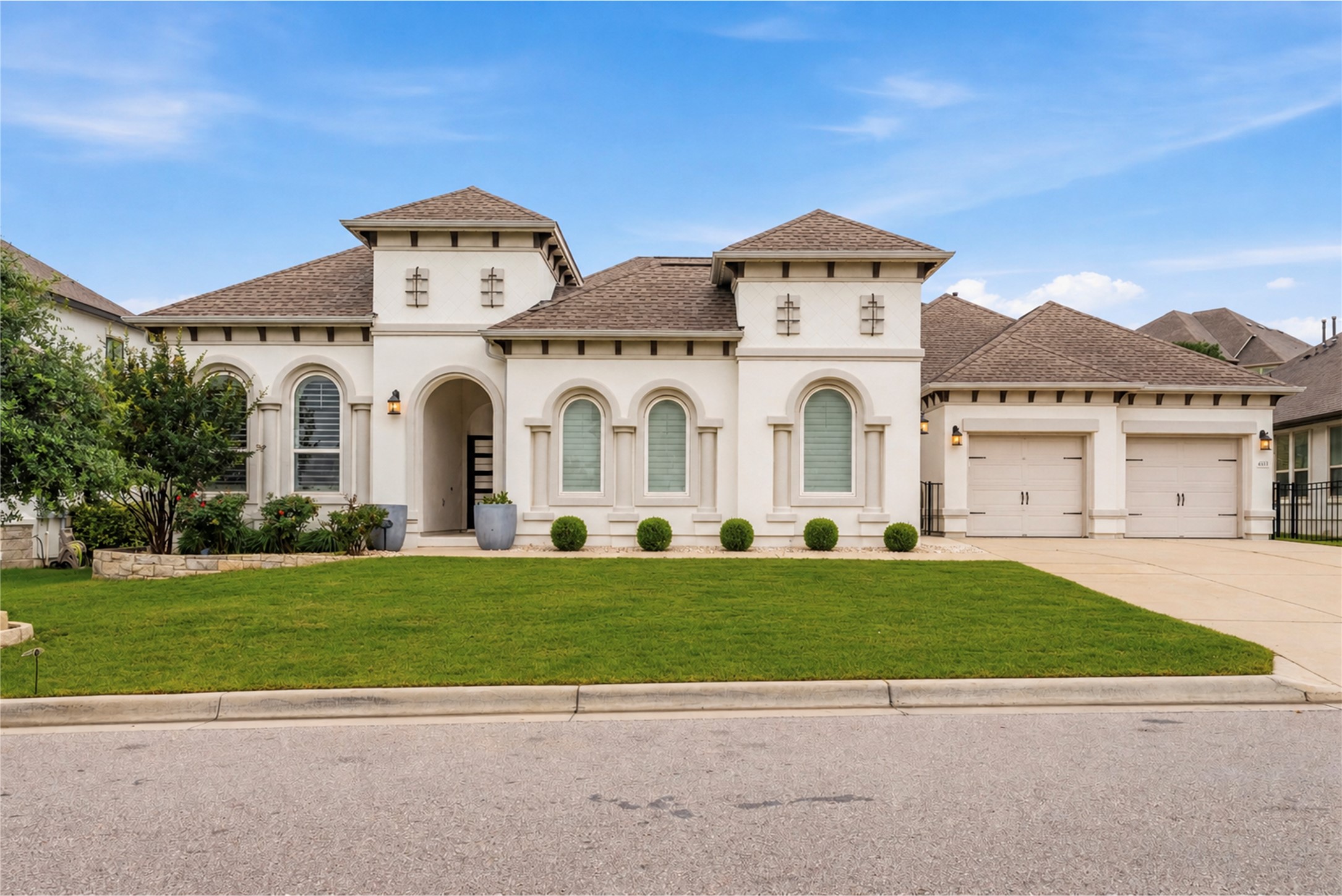 4513 Vieste View Leander, TX 78641 - Photo 2 of 40 Stucco exterior with arched windows, a covered entry, and a three-car garage
