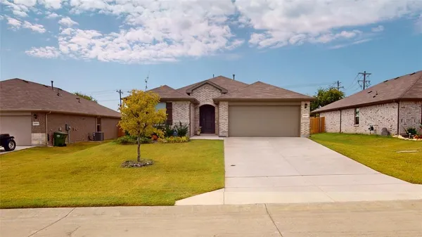a front view of house with yard and garage