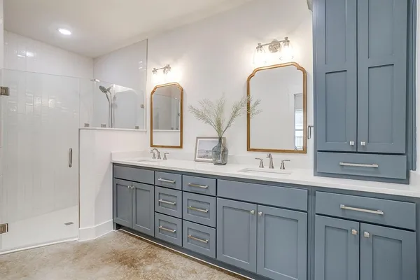 a bathroom with double vanity sinks and a mirror