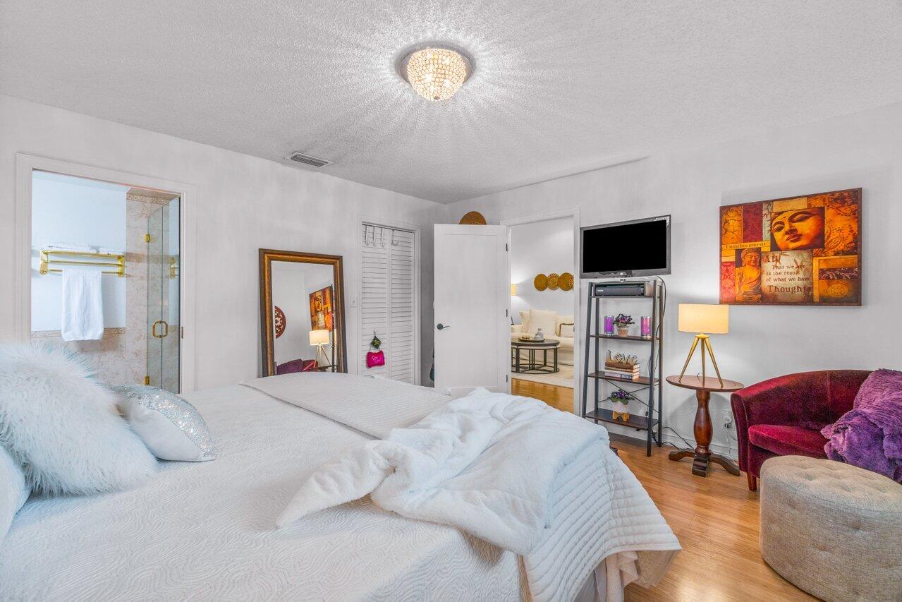 18855 Candlewick Drive Boca Raton, FL 33496 - Photo 19 of 27 a bedroom with a bed and a couch