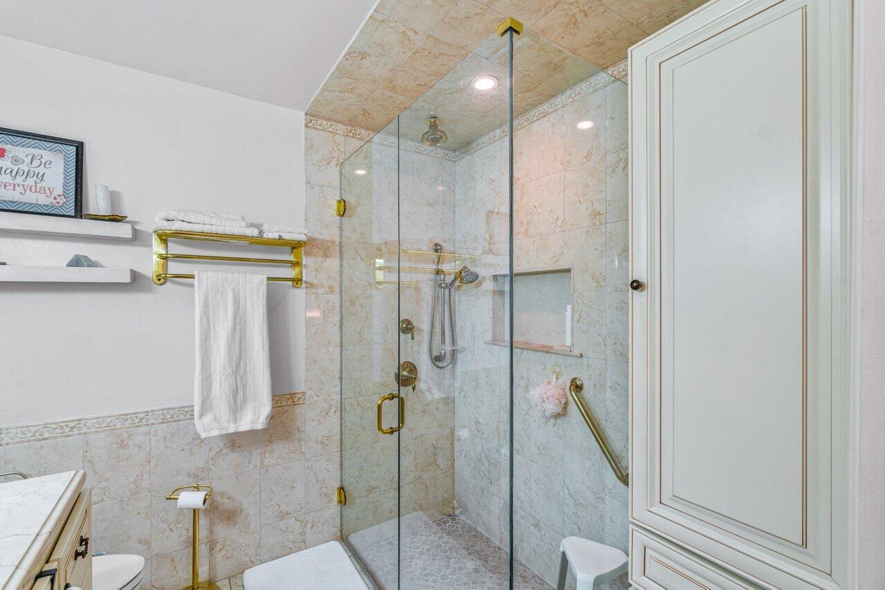 18855 Candlewick Drive Boca Raton, FL 33496 - Photo 21 of 27 a bathroom with a shower and a tub