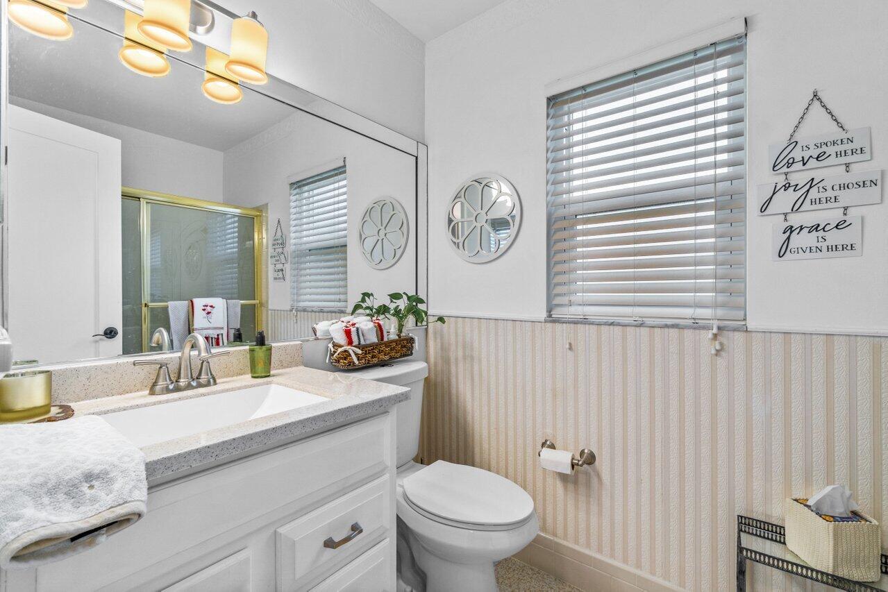 18855 Candlewick Drive Boca Raton, FL 33496 - Photo 22 of 27 a bathroom with a granite countertop sink mirror vanity and toilet