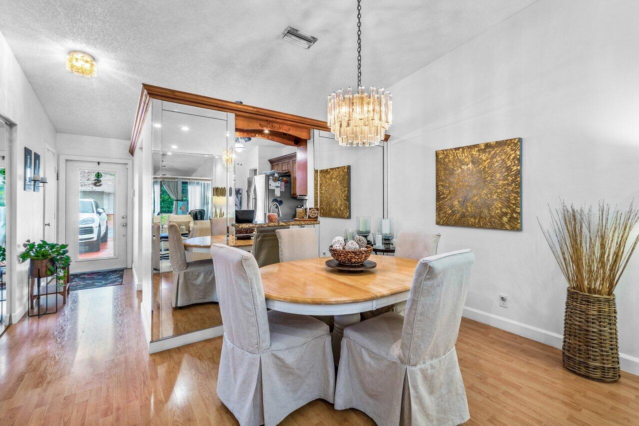 18855 Candlewick Drive Boca Raton, FL 33496 - Photo 5 of 27 a view of a dining room with furniture wooden floor and chandelier