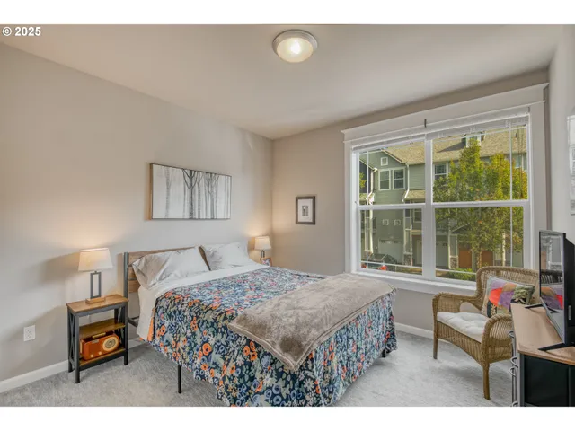 a bedroom with a bed a table and a window