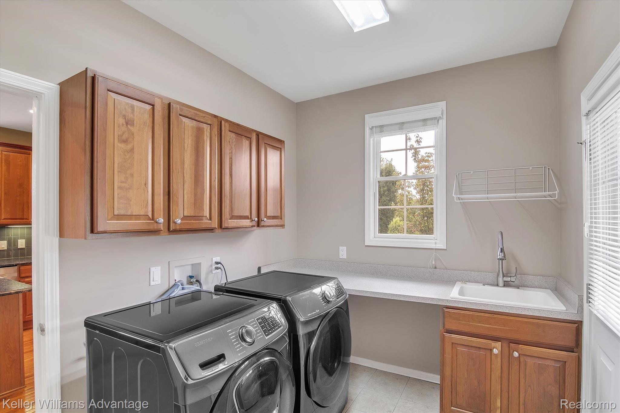 9042 Ridgefield Drive Brighton, MI 48114 - Photo 24 of 61 First floor laundry with direct access to the wraparound deck and the 3 car garage