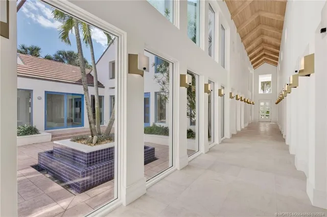a kitchen with kitchen island granite countertop a sink and refrigerator