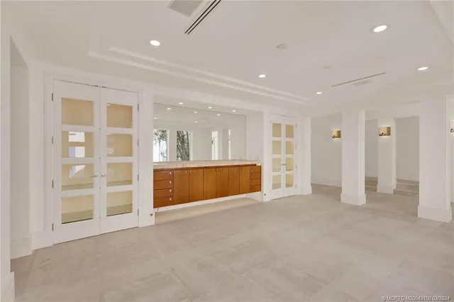 a spacious bedroom with a bed couch and a large window