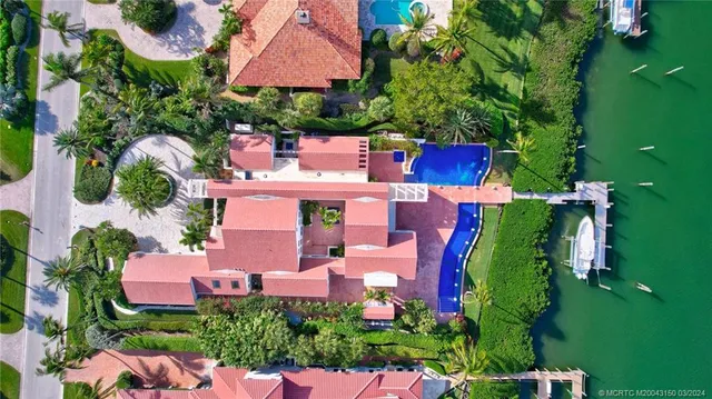 an aerial view of a houses with a lake view