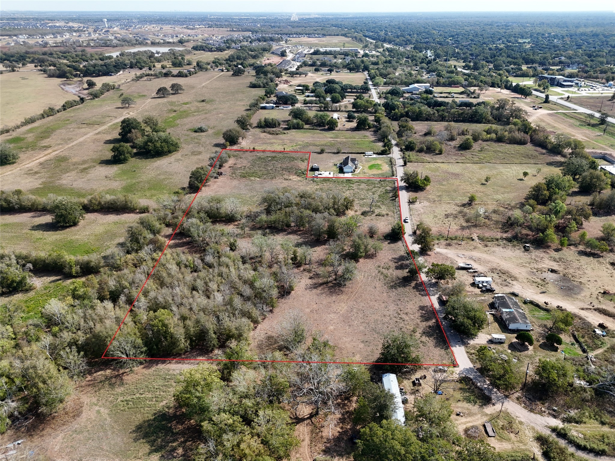 0 Reynolds Road Fulshear, TX 77441 - Photo 3 of 4 an aerial view of residential houses with outdoor space