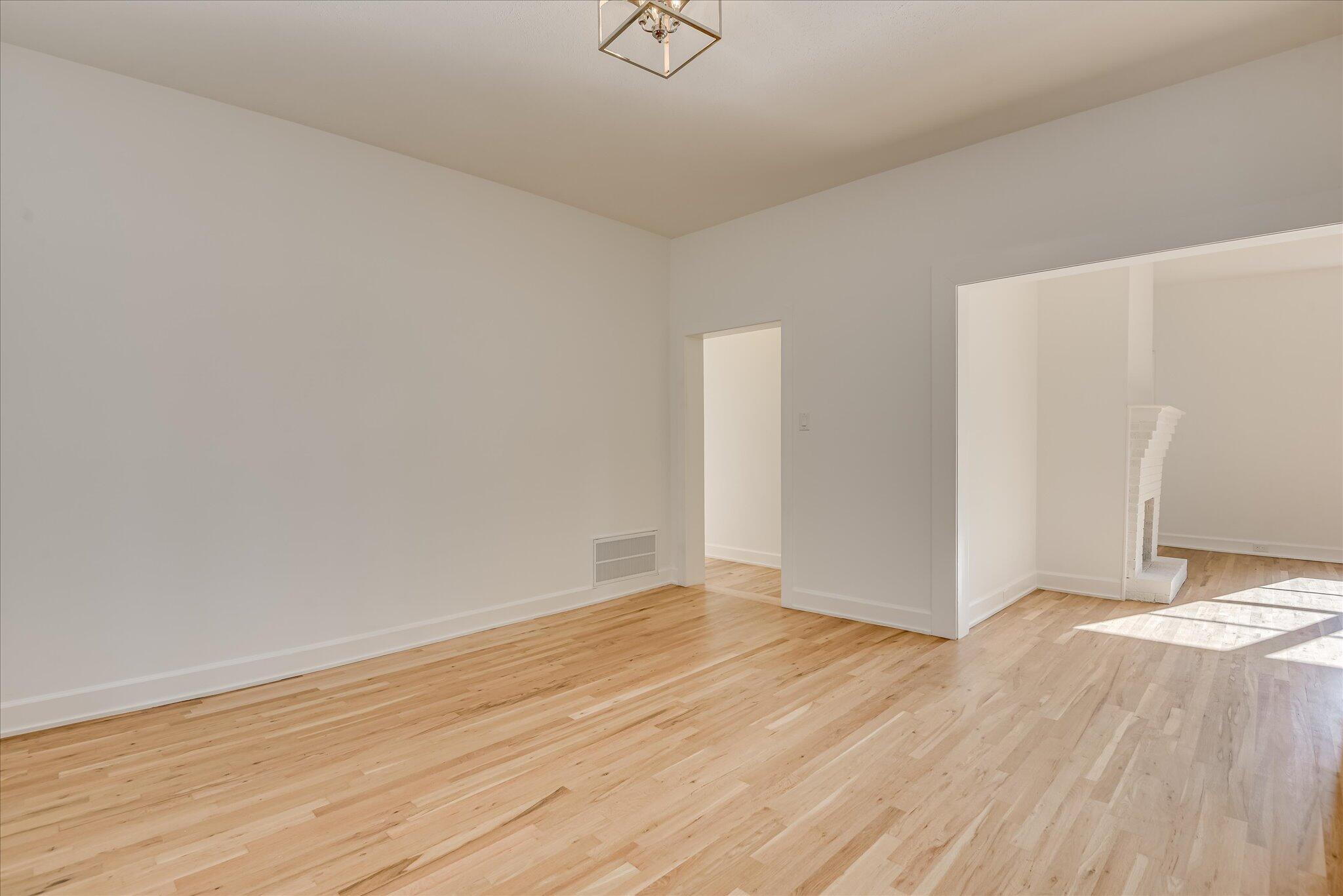 126 Mosley Road Aiken, SC 29801 - Photo 6 of 29 a view of an empty room with wooden floor and a window