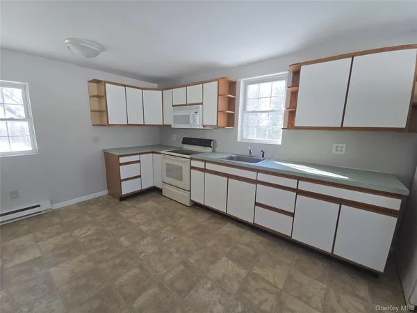 a kitchen with sink cabinets and window