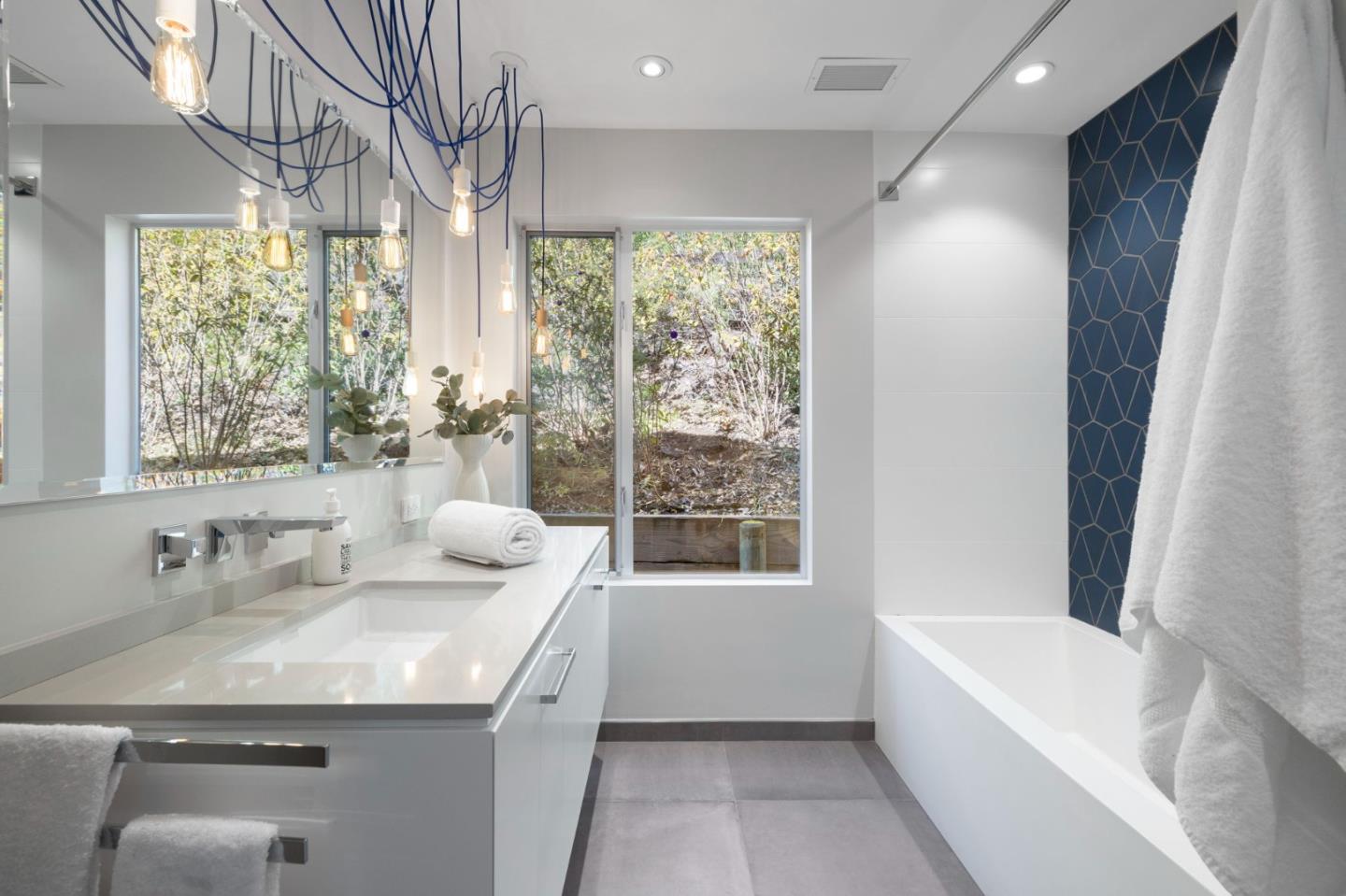 27201 Moody Road Los Altos Hills, CA 94022 - Photo 27 of 43 a bathroom with a granite countertop sink a mirror and a bathtub
